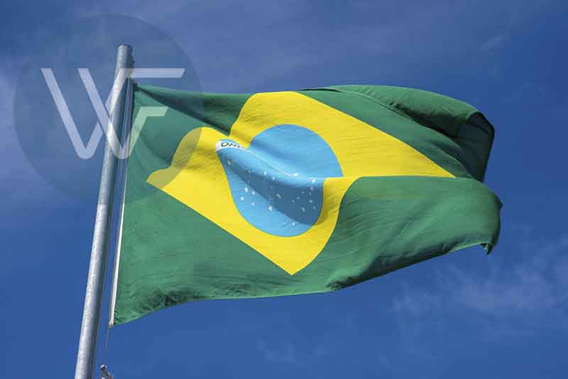Flag of Brazil featuring green background with yellow diamond and blue globe in the center.