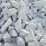 A pile of irregularly shaped gray kaolin clay rocks stacked together.