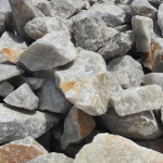A close-up view of a pile of gray and brown rocks with various shapes and sizes.