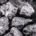 Close-up image of rough black rocks with various textures and shapes.