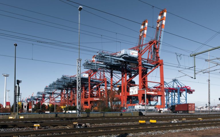 Dynamic view of cranes and shipping containers at Hamburg's bustling port.