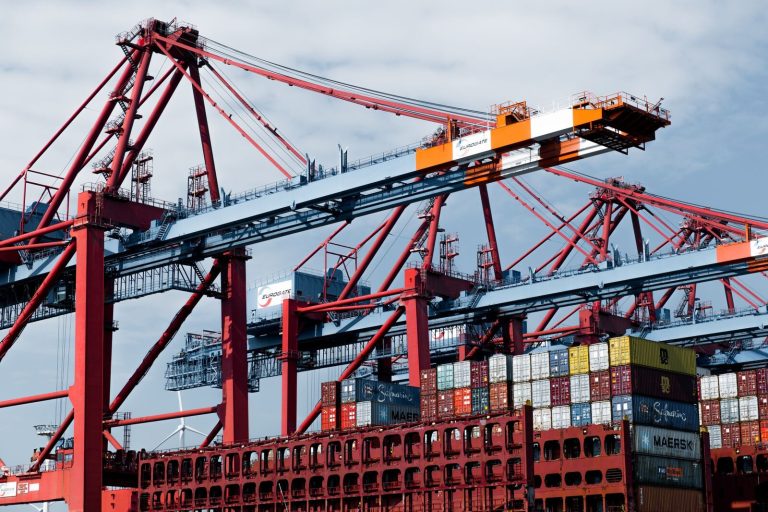 Cranes and shipping containers at Hamburg port, a hub of industry and trade.