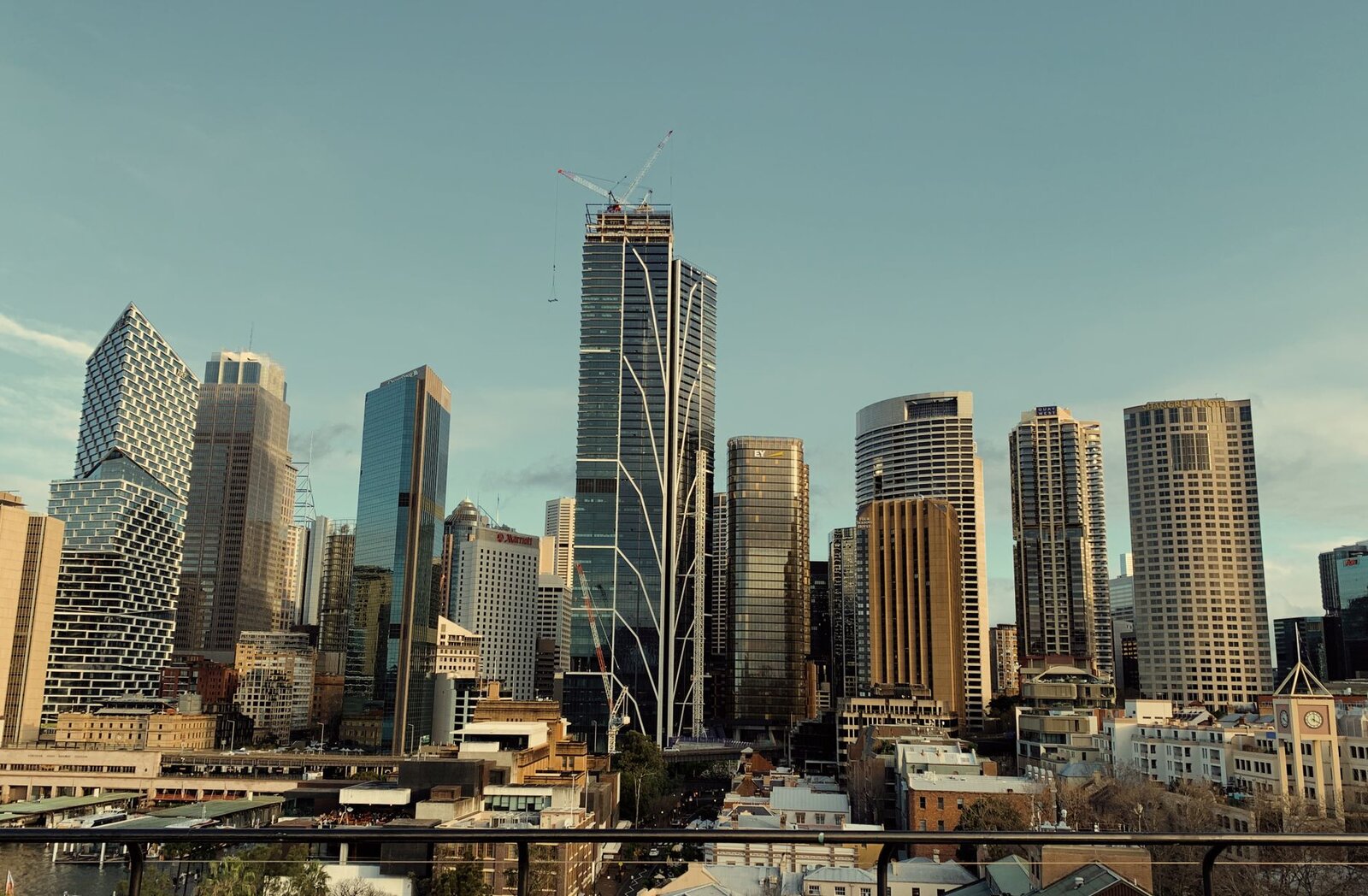 A stunning view of Sydney's skyline featuring modern skyscrapers and iconic architecture under a blue sky.
