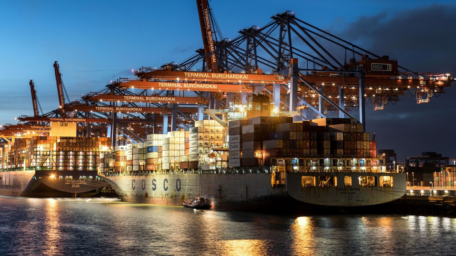 Vibrant evening view of cargo operations at Terminal Burchardkai, Hamburg.
