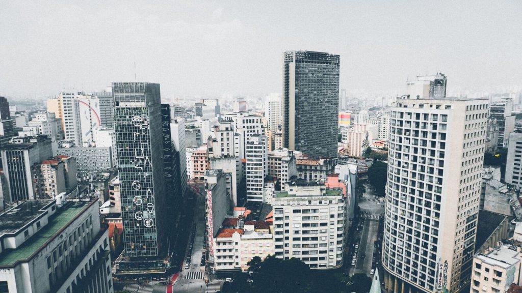 Vibrant urban cityscape showcasing diverse modern architecture under a clear sky.