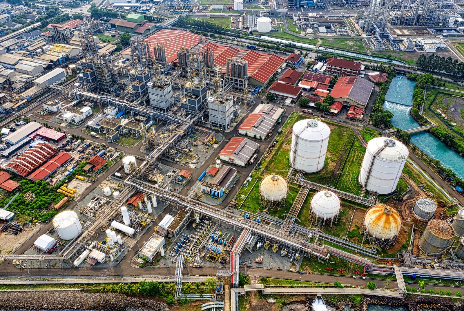 A detailed aerial view of an industrial facility in Banten, Indonesia, showcasing large tanks and architectural structures.